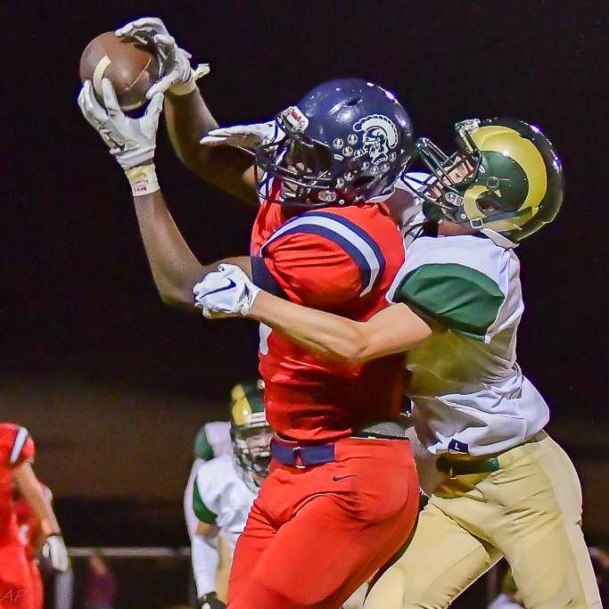 Kennedy's Emorej Lynk, intercepting a pass, scored four touchdowns against Regis. (Photo by Andre Panse)