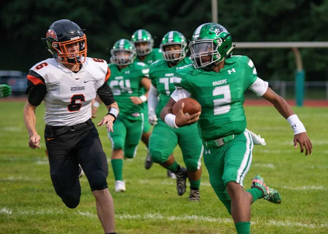 Reynolds quarterback Dominique Miller (2) runs from Roseburg's Carson Six (6). (Photo by Melissa Williams)