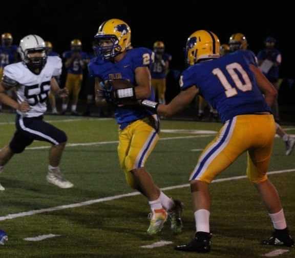 Toledo's Donovan Villanueva (24) takes a handoff from Jaxon Rozewski (10) on Friday night. (Photo by Aaron Wawrak)