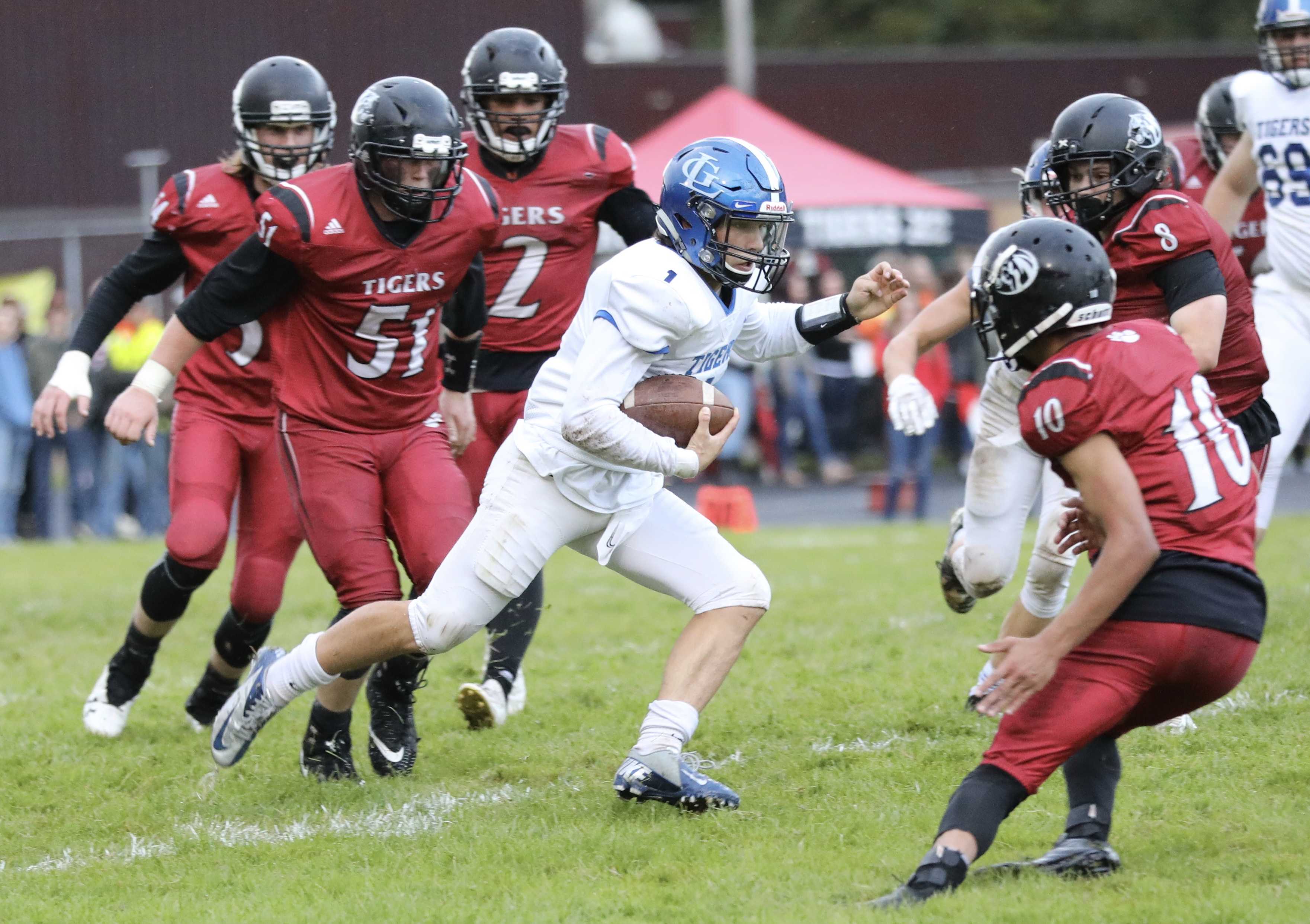 La Grande quarterback Parker Robinson slips through tacklers for a 10-yard gain. He threw for a score on the next play. (Maves)