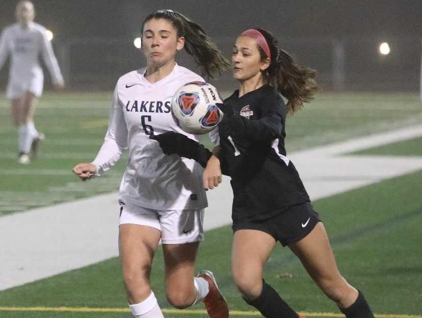 Lake Oswego's Natalie Redpath (6) and Sherwood's Alysia Alvarado contest a bouncing ball. (Photo by Norm Maves Jr.)