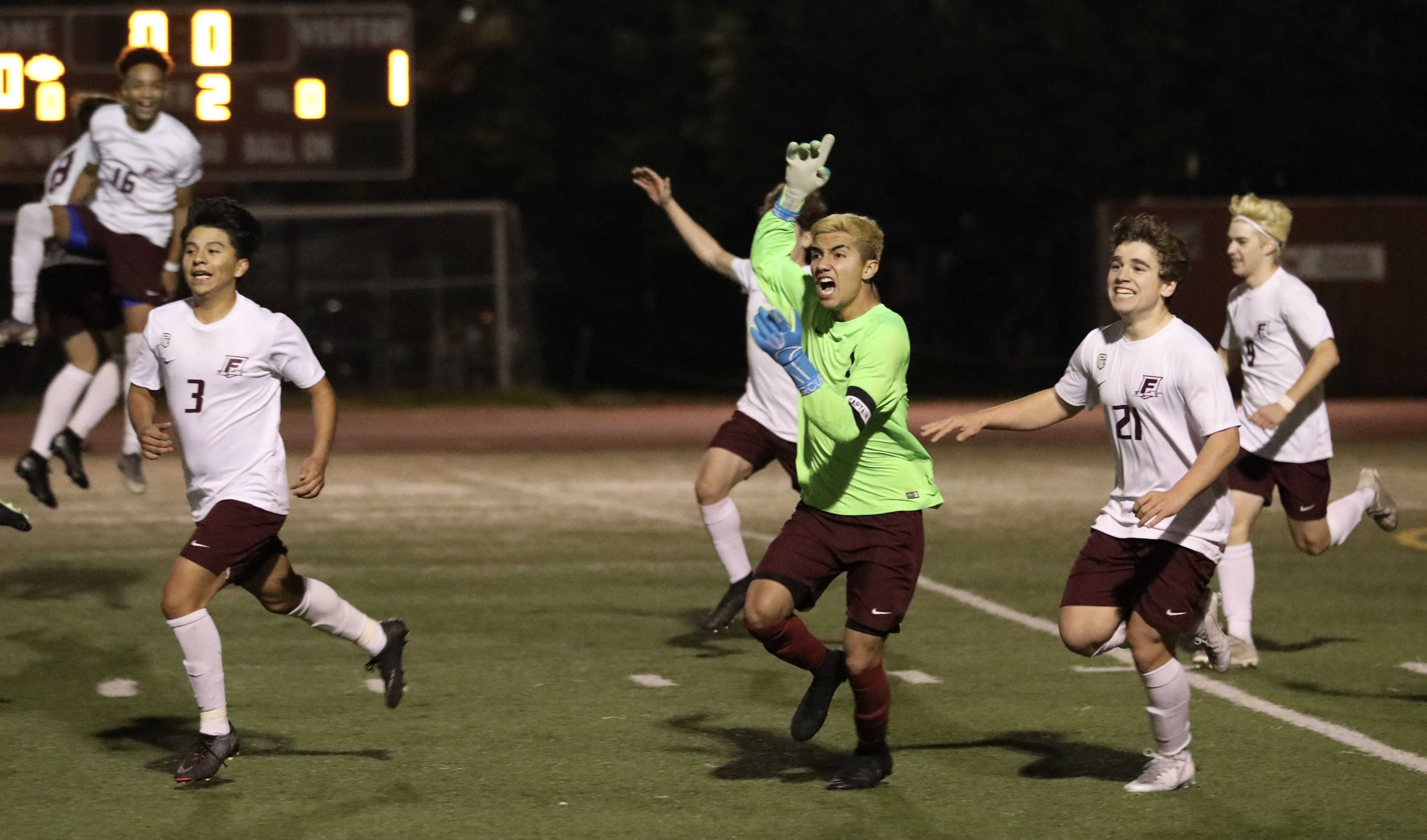 Franklin goalie Gael Salas-Lara (green jersey) leads his teammates toward the stands after their victory over Lincoln. (Maves)