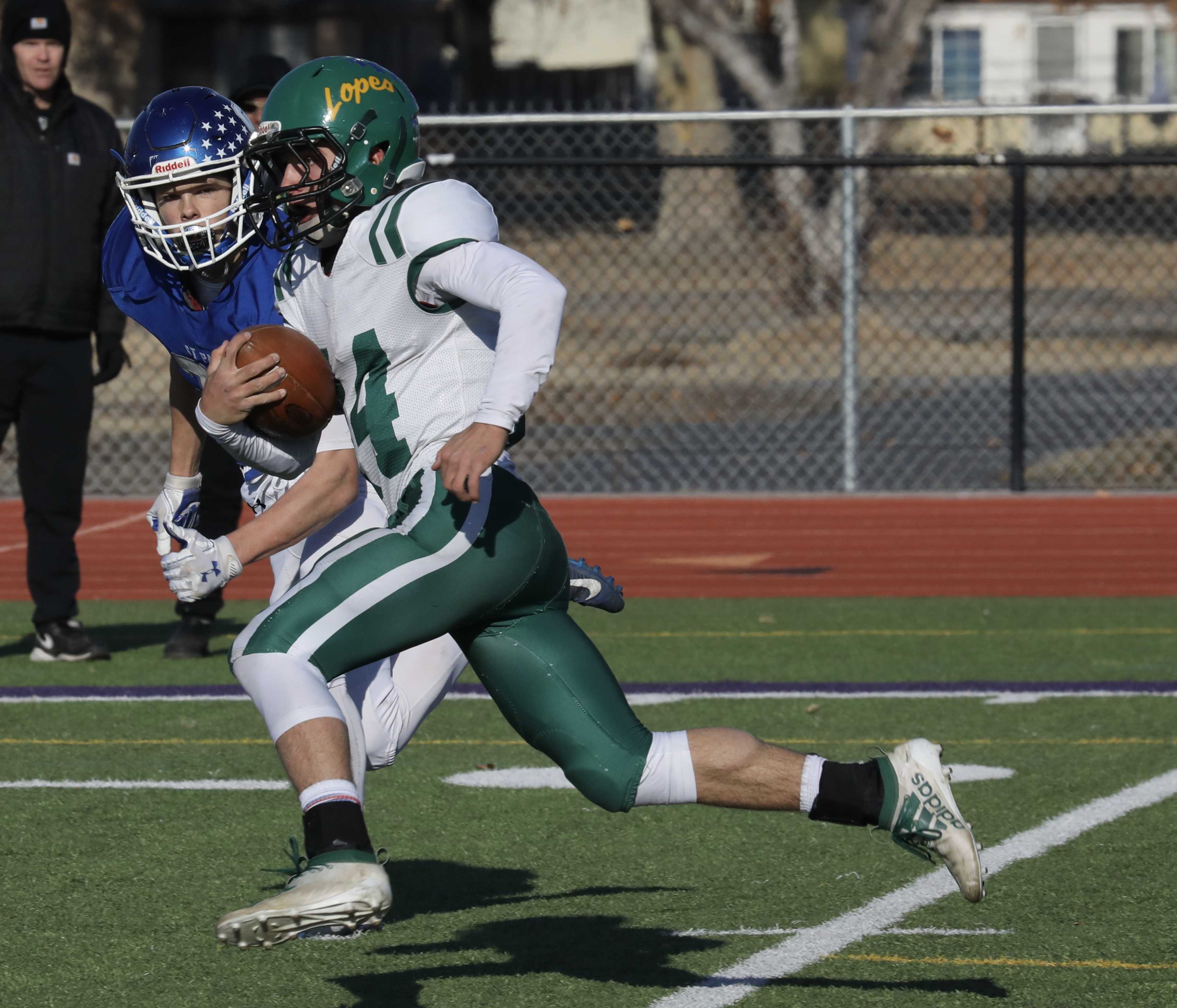 Adrian quarterback Conley Martin escapes from a St. Paul defender for one of his four touchdowns in Antelopes' 38-32 victory