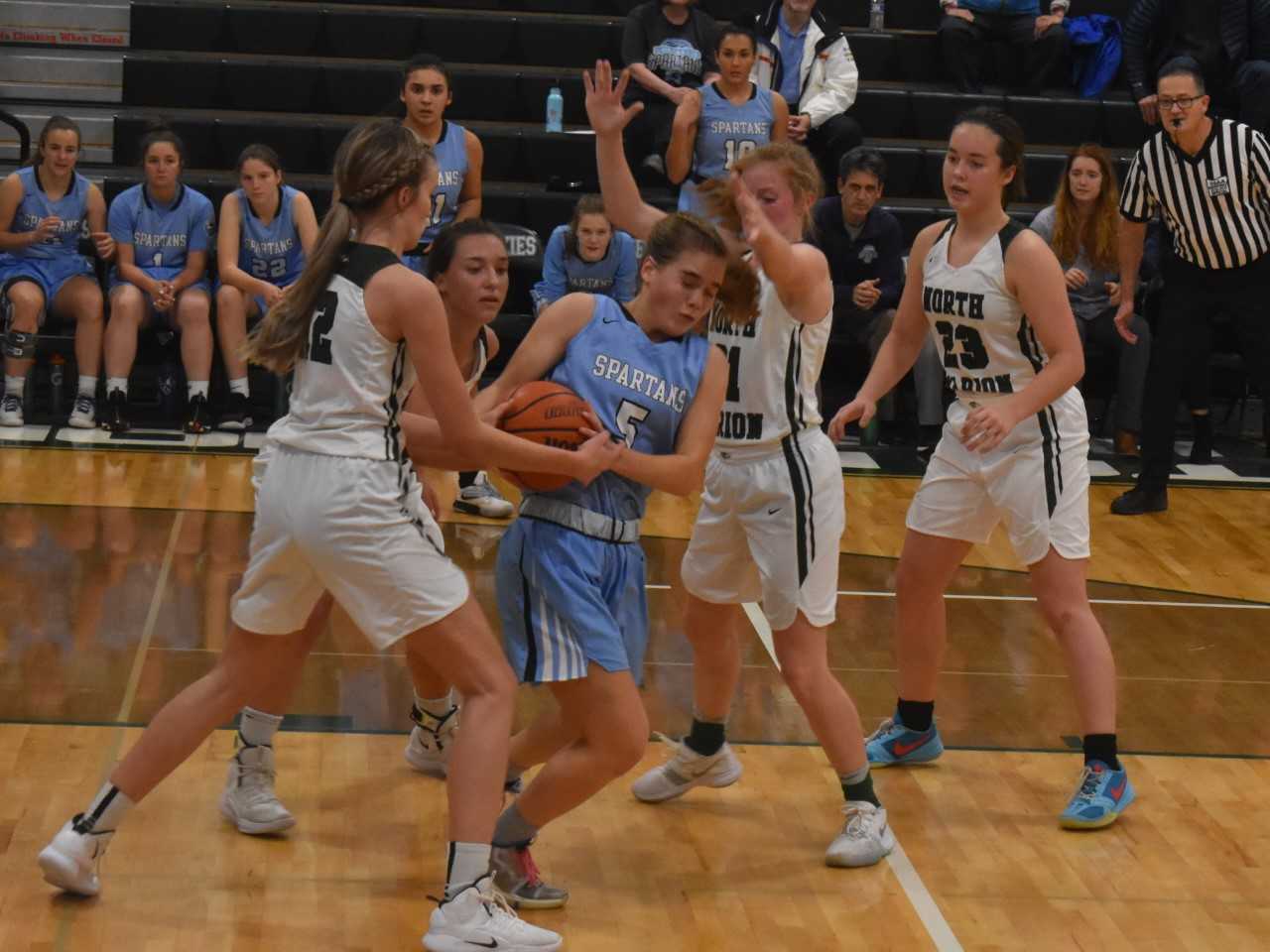 North Marion's Katie Ensign (12) tries to take the ball away from Corvallis' Anna Dazey. (Photo by Jeremy McDonald)