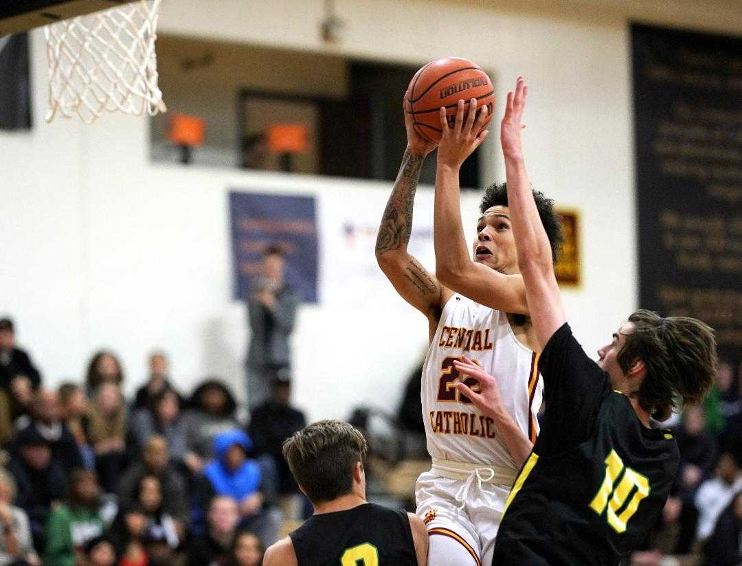 Central Catholic's Isaiah Amato (22) rises over West Linn's Mason VanBeenan. (Photo by Jon Olson)