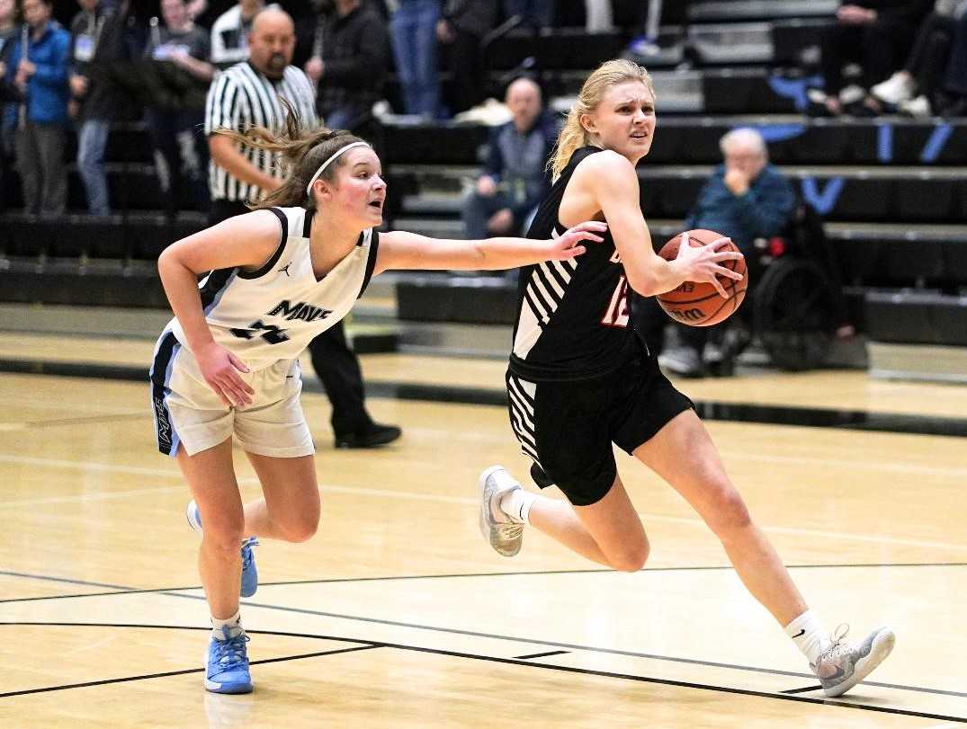 Beaverton's Mary Kay Naro drives past Mountainside's Halle Hageman on Tuesday. (Photo by Jon Olson)