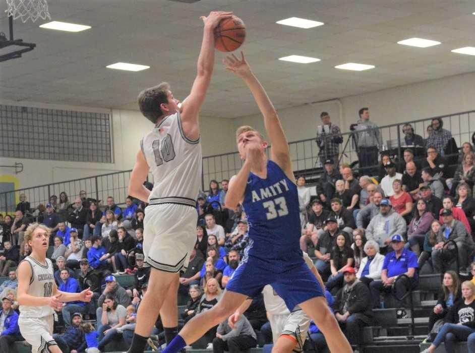 Salem Academy's Bennet Bos (10) blocks Amity's Josh Wart (33) on Friday night. (Photo by Jeremy McDonald)