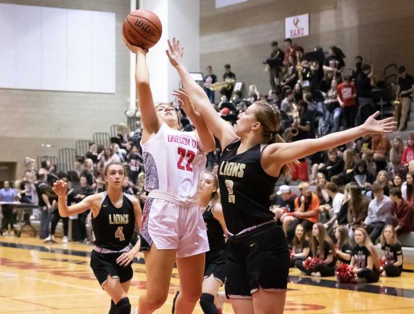 Oregon City's Katie Kathan (22) shoots over West Linn's Cami Fulcher on Friday night. (Photo by Gene Schwartz)