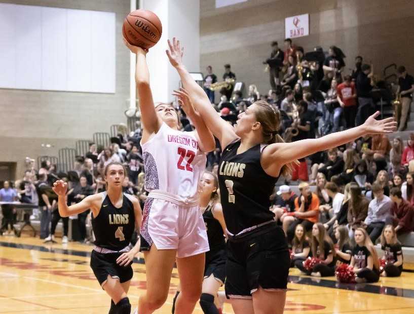 Oregon City's Katie Kathan (22) shoots over West Linn's Cami Fulcher on Friday night. (Photo by Gene Schwartz)