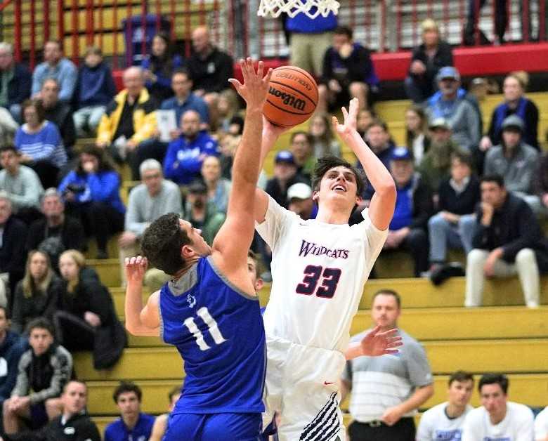 Westview's Brady Grier (33) shoots over Grants Pass' Chase Coyle on Wednesday night. (Photo by Jon Olson)