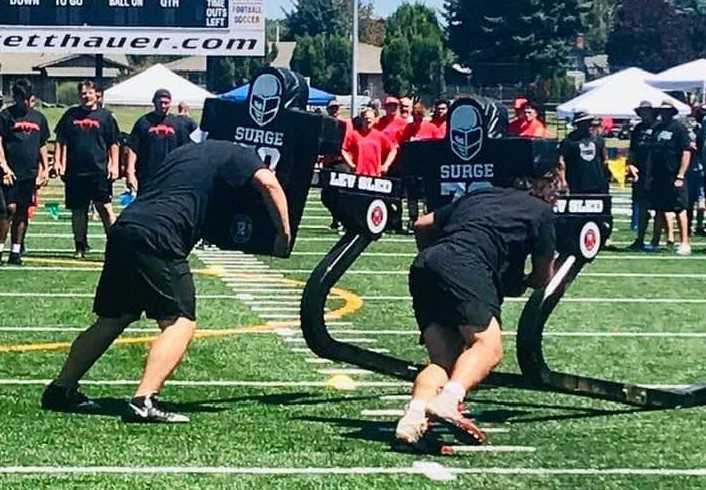 Linemen go through drills in a camp at Hillsboro's Hare Field last summer. (Photo courtesy Clackamas Touchdown Club)