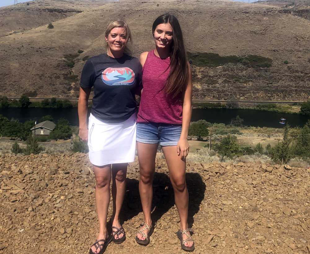 Holly Miles, right, and mom, Susie, pose on the new fill that will be part of the 200m corner at South Wasco County HS