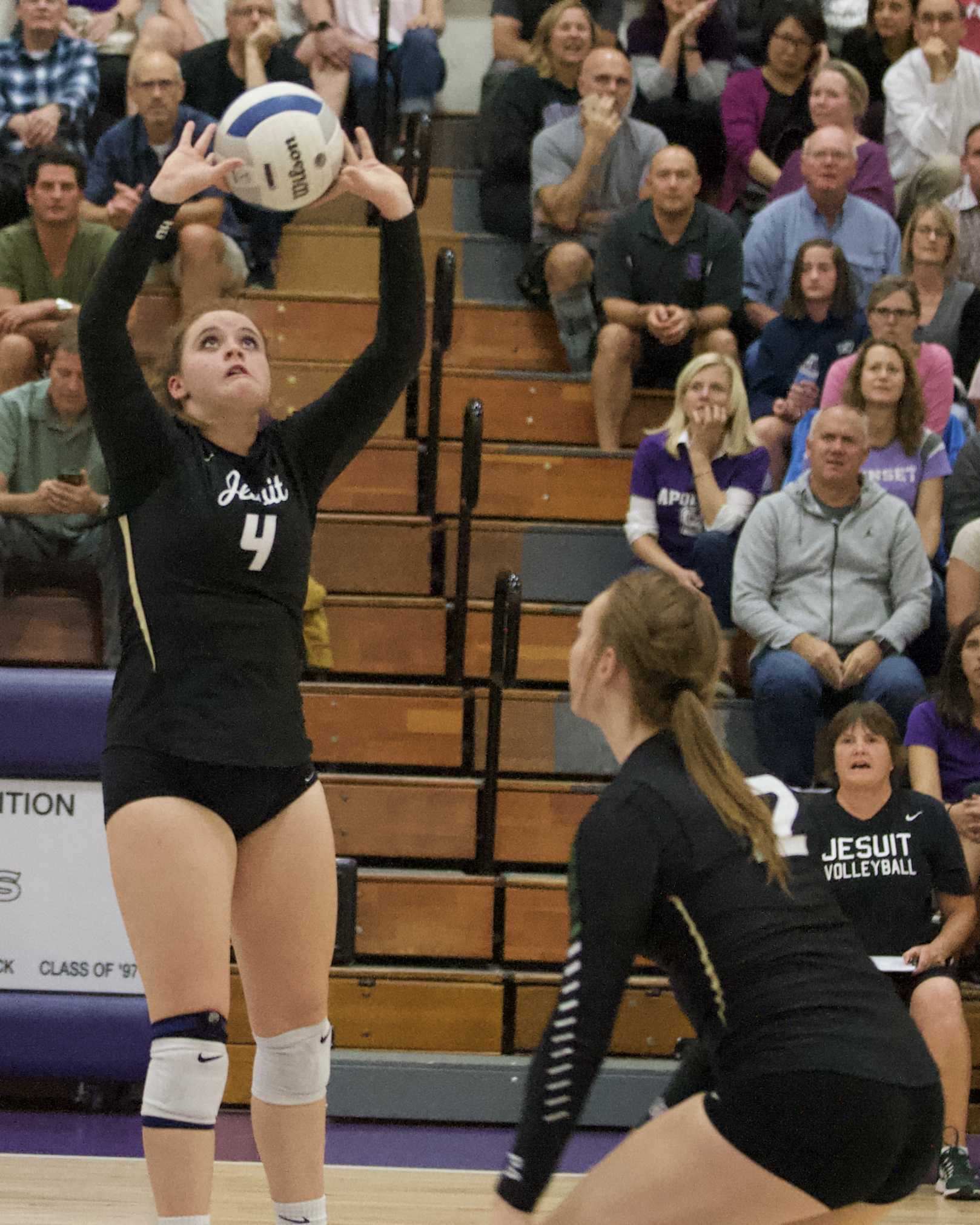 Jesuit setter Alison Buchholz (4) pops one of her 48 assist passes to waiting middle blocker Alyssa Hughes for a Crusader kill.