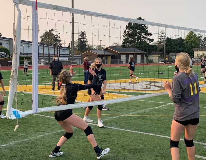 North Bend's Bridget Gould (left) sets to Sophia Macduff in an outdoor volleyball match Tuesday. (Photo courtesy North Bend HS)
