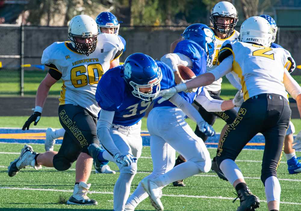 Max Brown (60) and Collin Ewing (2) close in on a ball carrier. Camas Valley traditionally has a hard-hitting defense.