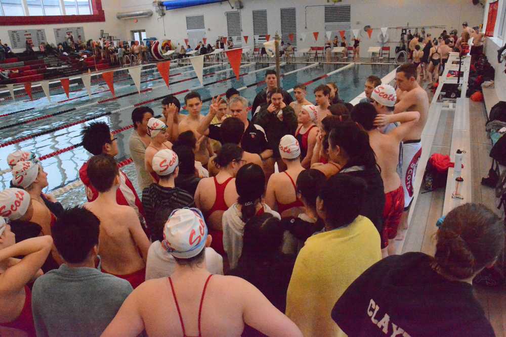 Jim Bowe talks to his swimmers inside the new aquatic facility at David Douglas HS