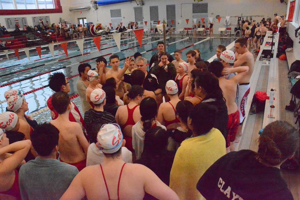 Jim Bowe talks to his swimmers inside the new aquatic facility at David Douglas HS