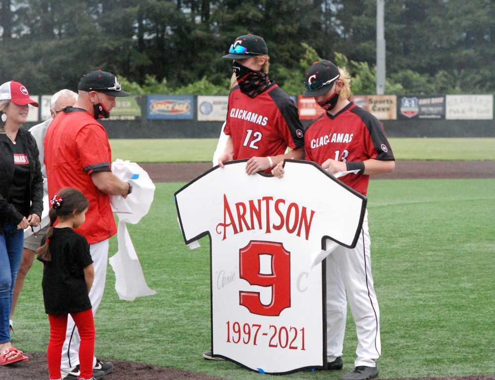 J.D. Dorn (12) and K.C. Miller held coach John Arntson's retired jersey initially.