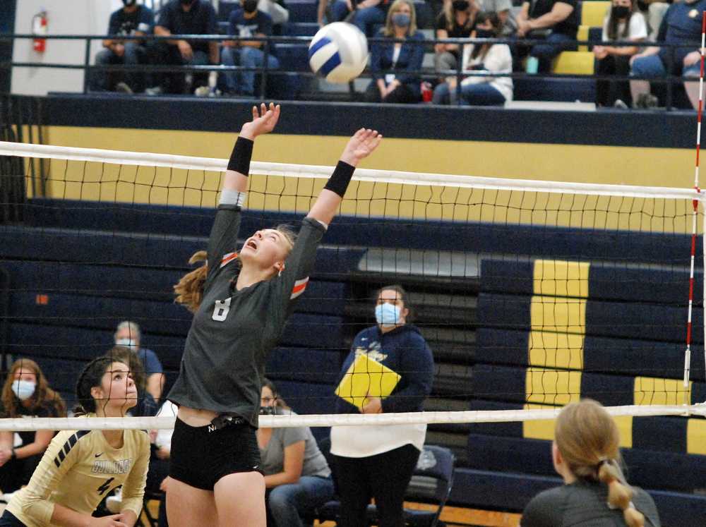 Alexis Haury delivers the back set for Silverton as West Albany's Kendyl Arnett prepares to block