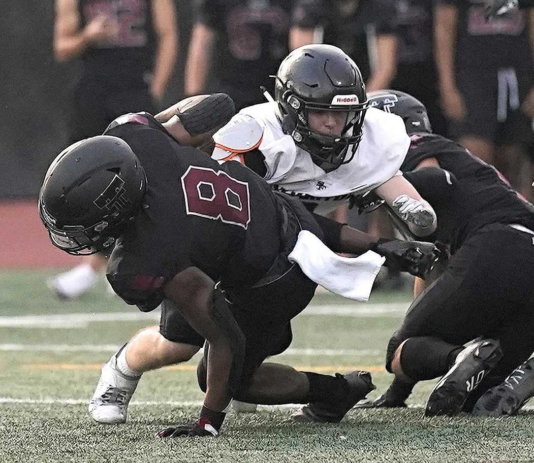 Tualatin's Malik Ross (8) fights for yards Friday night against Silverton. (Photo by Jon Olson)