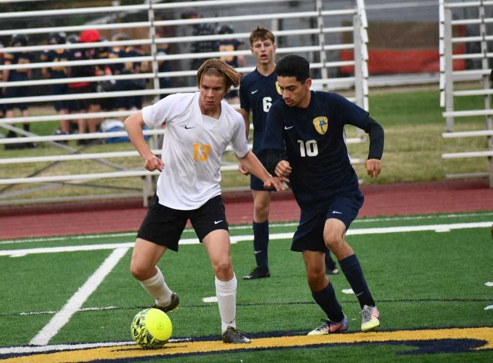 Philomath's Mateo Candanoza (13) battles against Stayton's Jayden Esparza (10) on Thursday. (Photo by Jeremy McDonald)