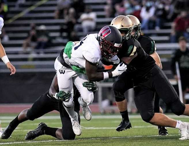 Westview's Jordan Fisher, fighting for yards against Jesuit, ran for a 288 yards Friday against Sunset. (Photo by Jon Olson)