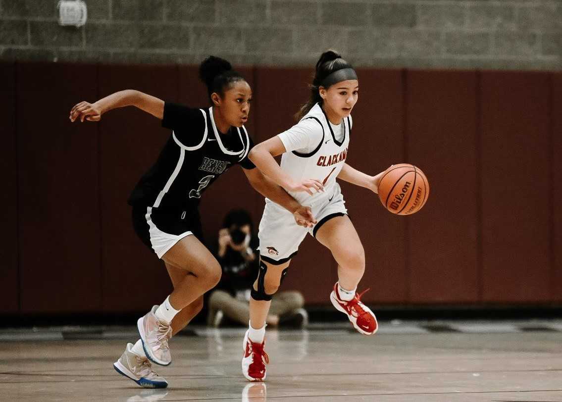 Clackamas' Avery Peterson works against the pressure of Benson's Maurianna Hashemian-Orr. (Photo by Faith Mithmeuangneua)