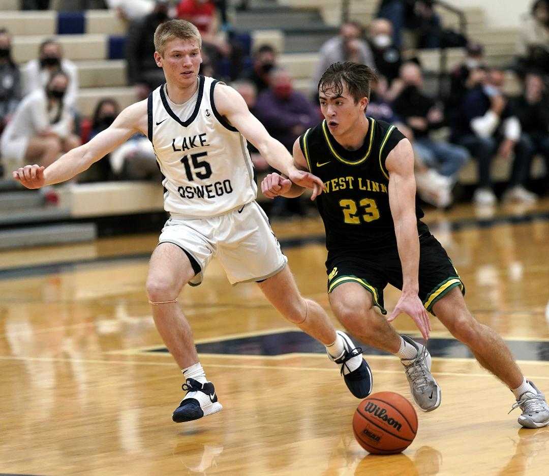 West Linn's Zeke Viuhkola, guarded by Lake Oswego's Zane Fisher, scored 26 points Thursday night. (Photo by Jon Olson)