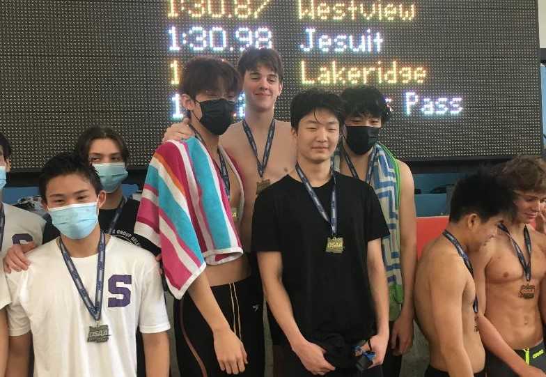 Lake Oswego's 200 freestyle relay team (center) set an OSAA meet record that had stood since 1998.