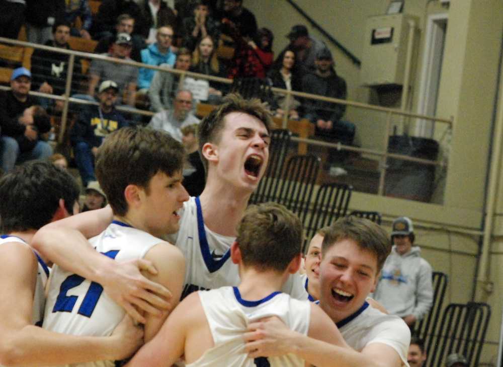 Chaz Storm (middle) celebrates with Owen Stalnaker (21) and other Western Christian players after their 2 OT win at state