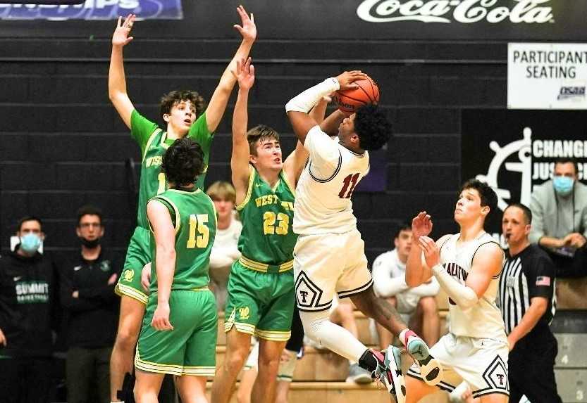 Tualatin's Malik Ross shoots over West Linn in the Timberwolves' 56-49 semifinal win Friday. (Photo by Jon Olson)