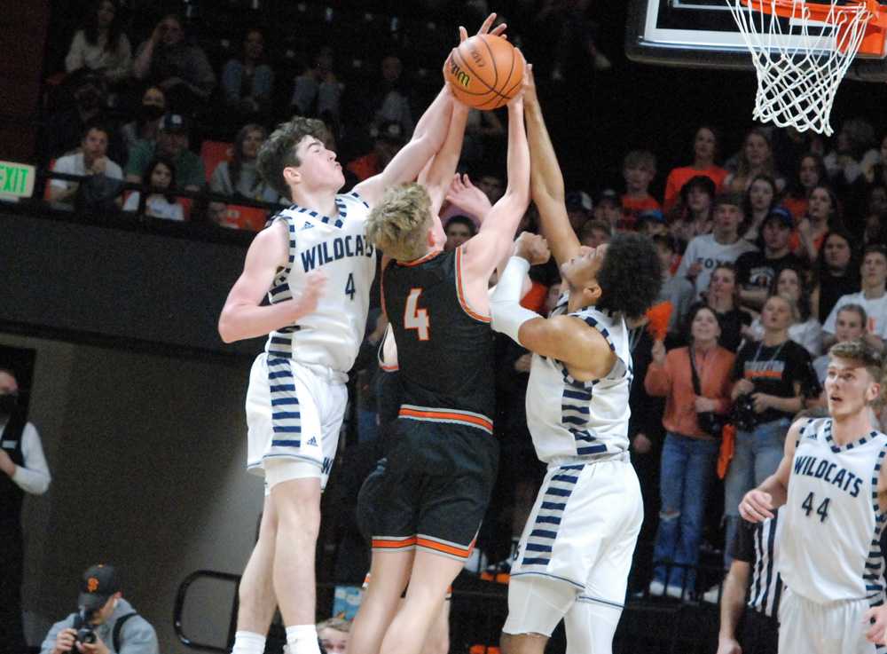 Wilsonville's Kallen Gutbridge (4) and Tristan Davis defend the hoop from Joseph Haugen of Silverton in the 34-30 win