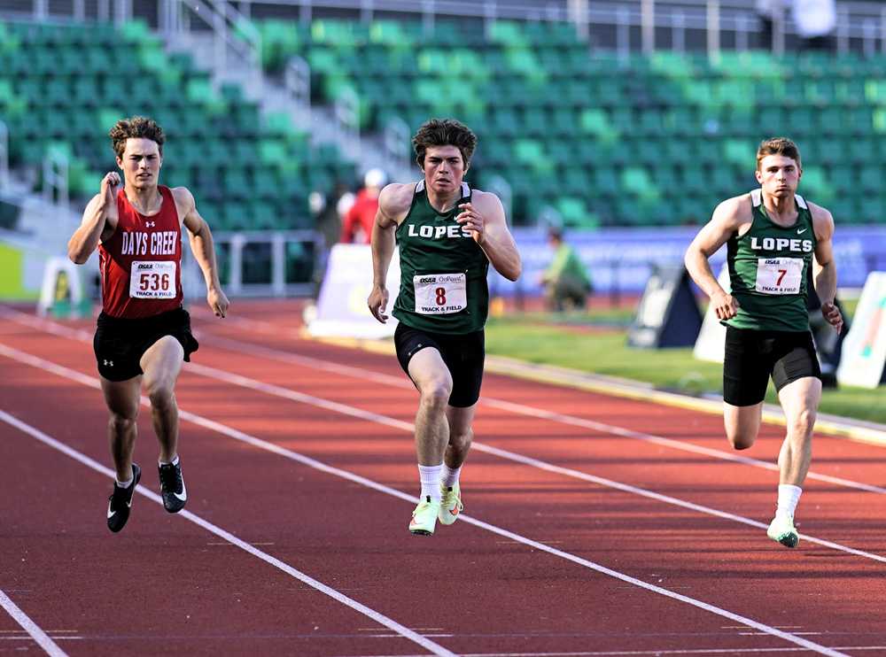 Adrian sprinter Jace Martin (center), flanked by his brother, Conley, and Kacey Benefiel wins the 200-meter dash (Jon Olson)