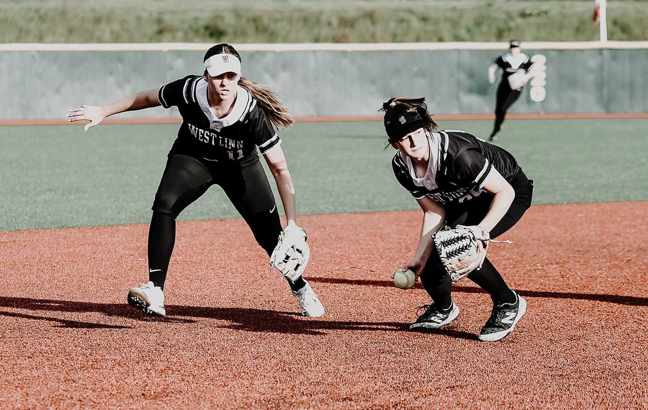 West Linn's Cydney Hess (left) and Gracie Gabel converge on defense against Tualatin. (Photo by Fanta Mithmeuangneua)