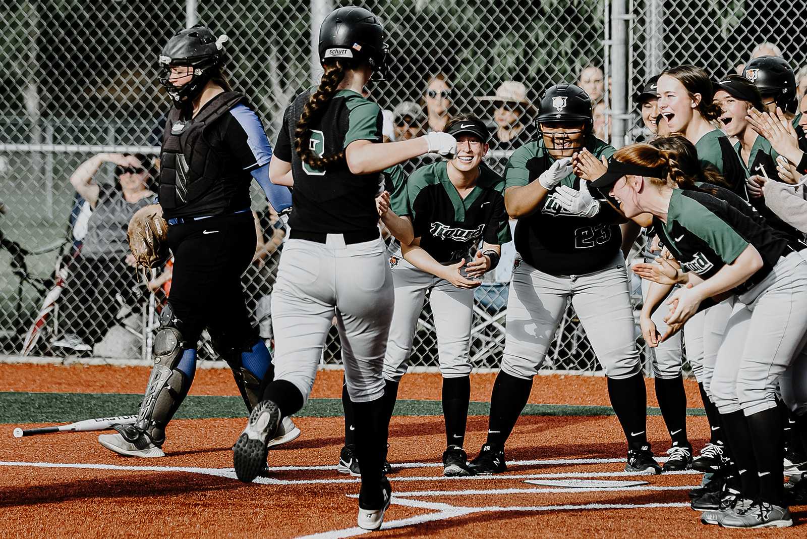 Tigard players greet Karen Spadafora after her fifth-inning home run opened a 6-1 lead. (Photo by Fanta Mithmeuangneua)
