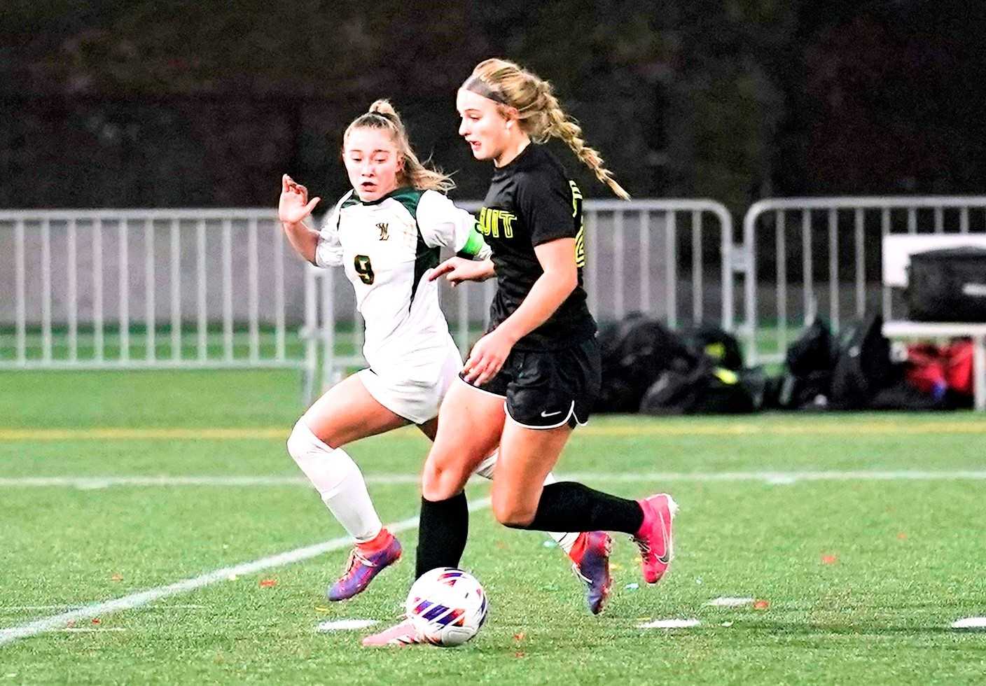 Jesuit's Mariane Dunne (right) pushes the ball against the defense of West Linn's Kelan Betts. (Photo by Jon Olson)