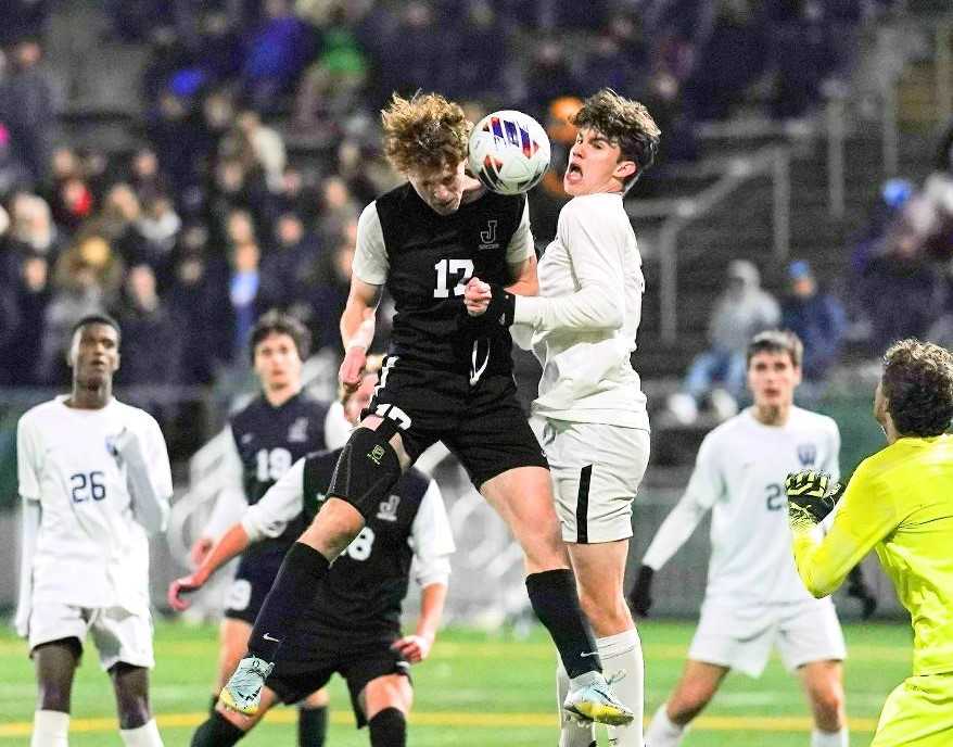 Jesuit's Drew Pedersen (17) goes up for a header to score his team's fourth goal Saturday night. (Photo by Jon Olson)