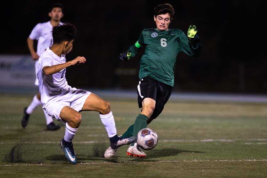 Simon Kidder dribbles for Summit against the challenge of David Douglas' Gustavo Perez. (Photo by Rob Kerr)