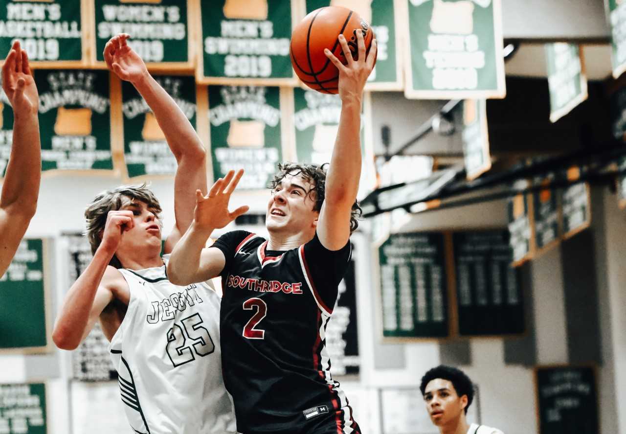 Southridge's Carter Fortune (2) drives against Jesuit's Nico Rafalovich (25) on Tuesday night. (Photo by Fanta Mithmeuangneua)