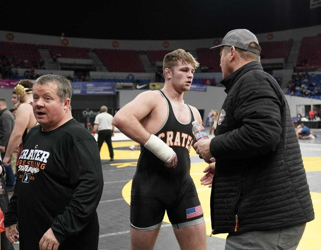 Crater's Hayden Walters, with coach Greg Haga (right), is back after dislocating his wrist in December. (Photo by Jon Olson)
