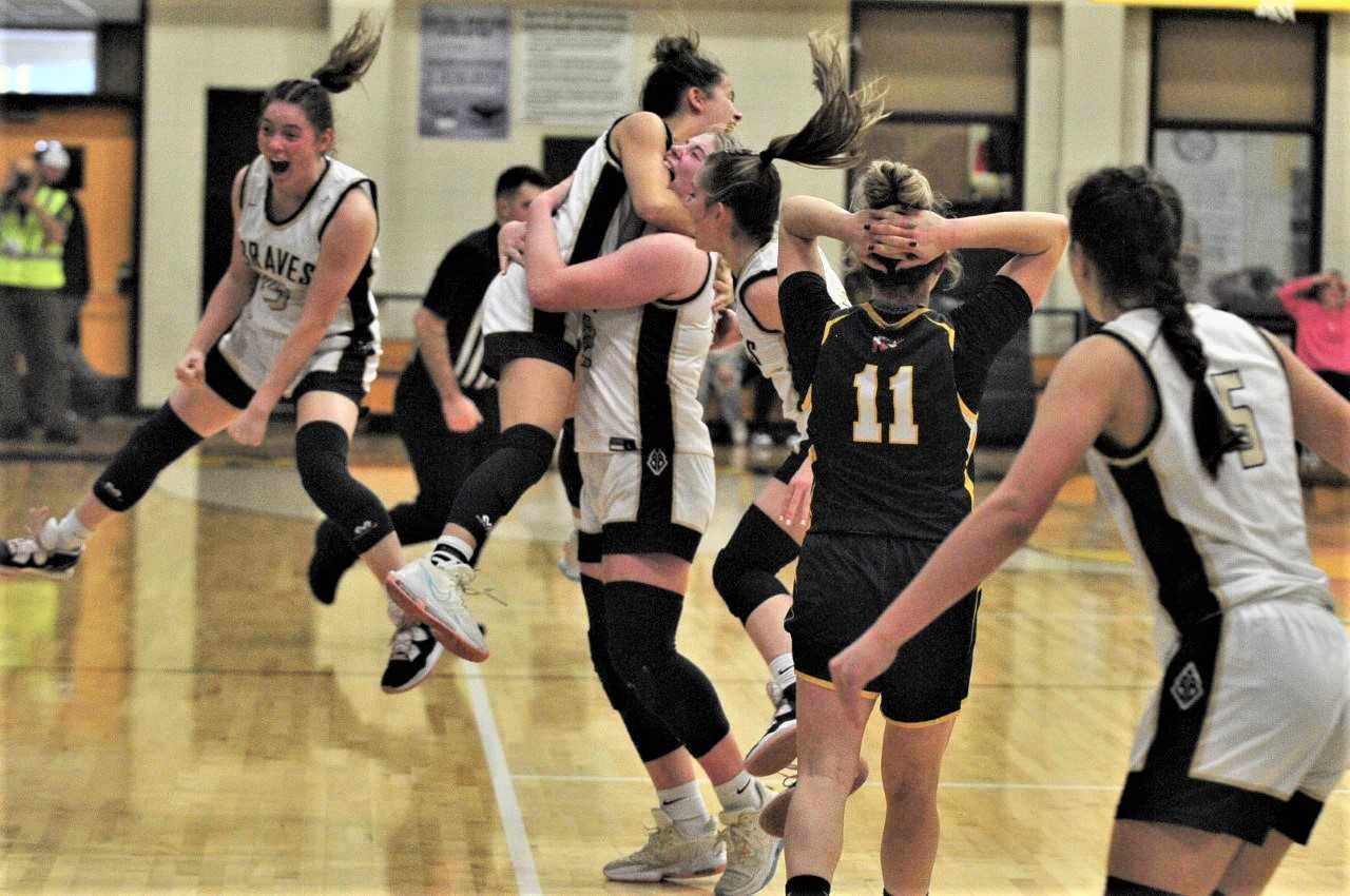 Madison Walker hugs Jocelyn Janecek as they celebrate Banks' win over Lakeview on Thursday. (Photo by John Gunther)