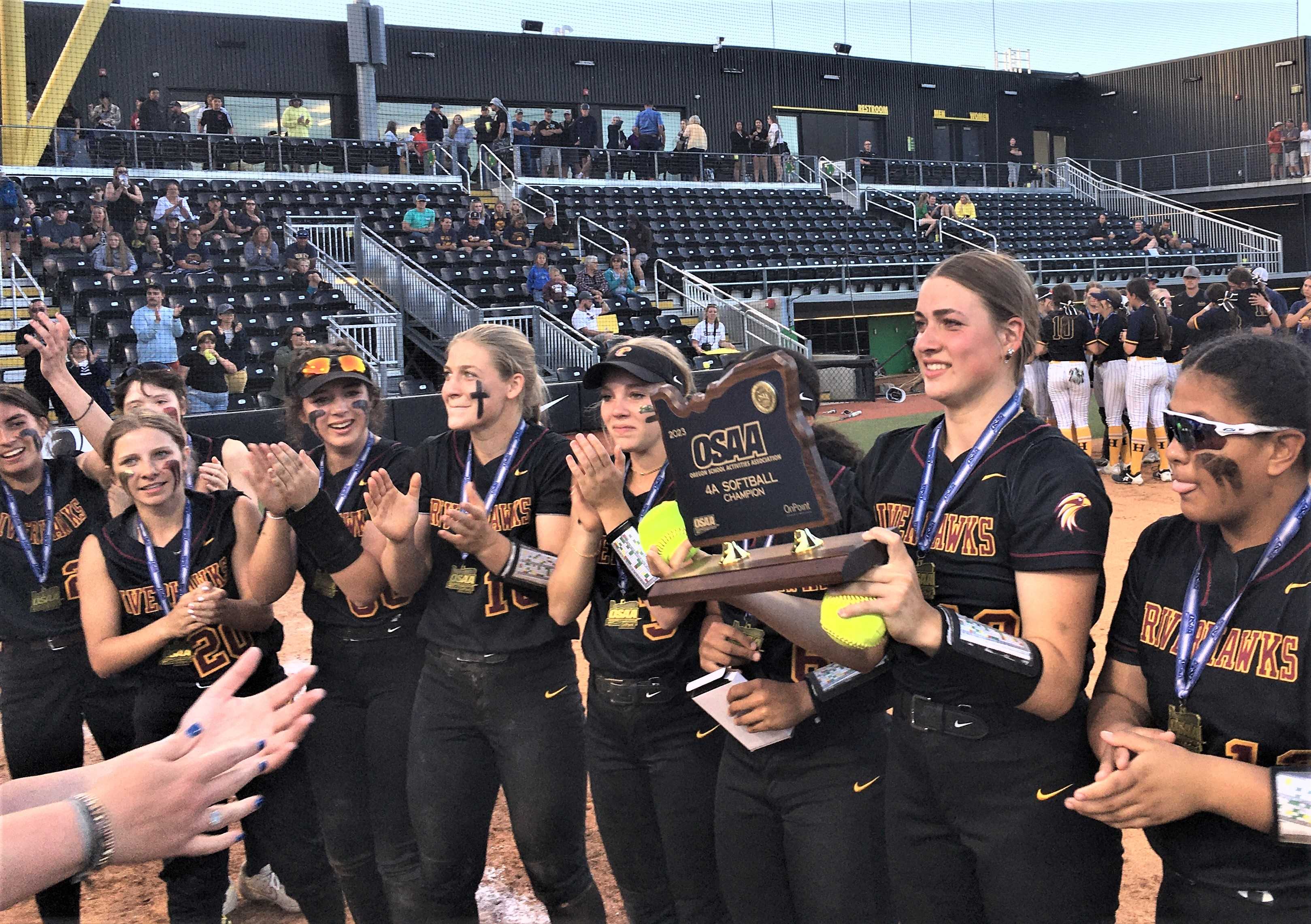 The Dalles senior Kennedy Abbas (holding trophy) pitched a one-hitter in a 16-0 win over Henley on Saturday.