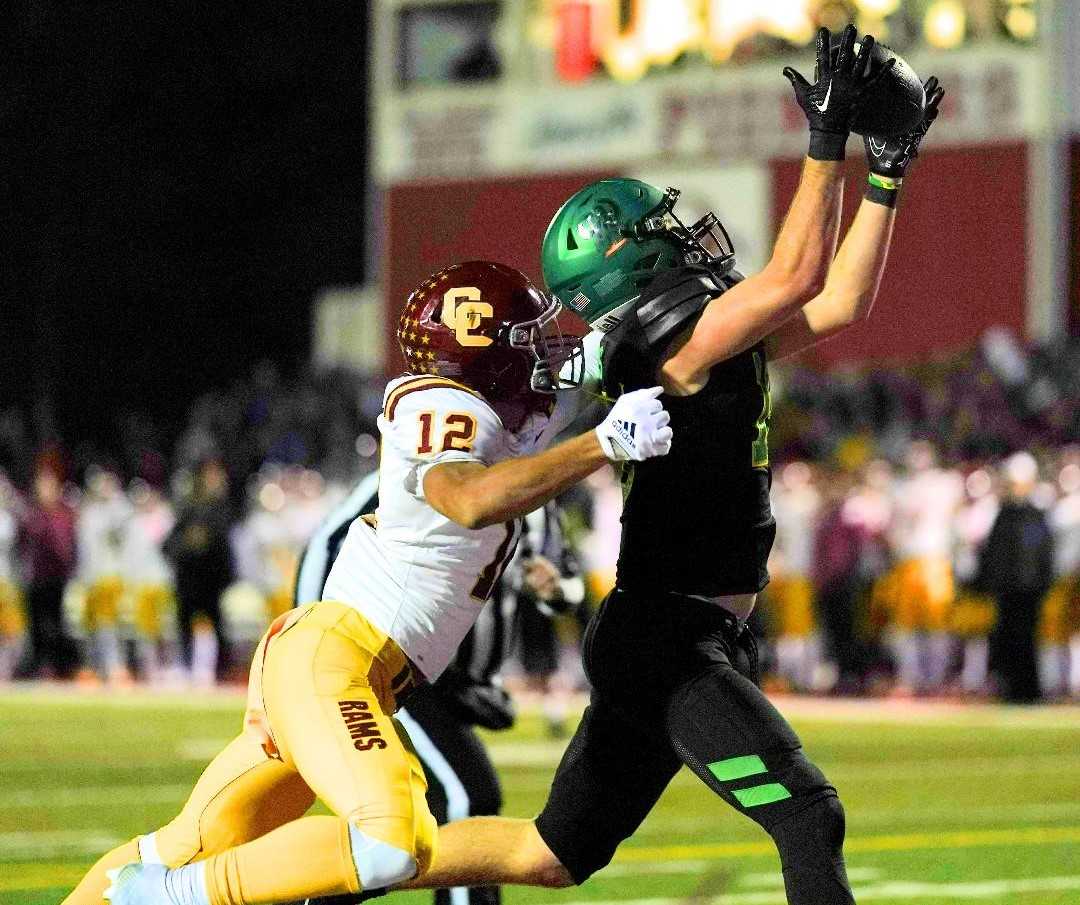 West Linn's Baron Naone goes up for a pass against Central Catholic's Zhaiel Smith (12) on Friday. (Photo by Jon Olson)