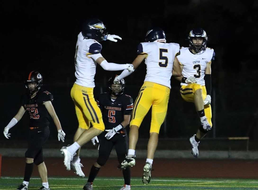 Stayton's Caden Moore (1), Ethan Whieldon (5) and Kaden Arnold (3) celebrate a touchdown last week. (Photo by Bre Hughes)