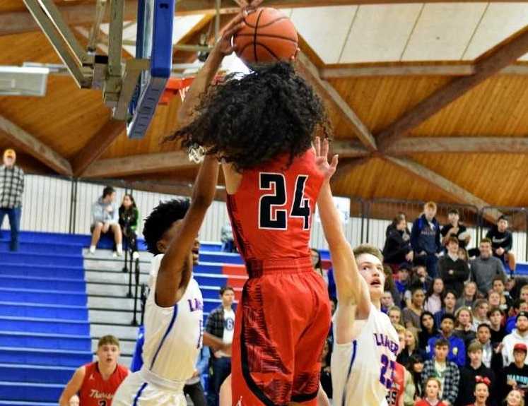 Thurston's Isaac Lange shoots over the Churchill defense Tuesday night.