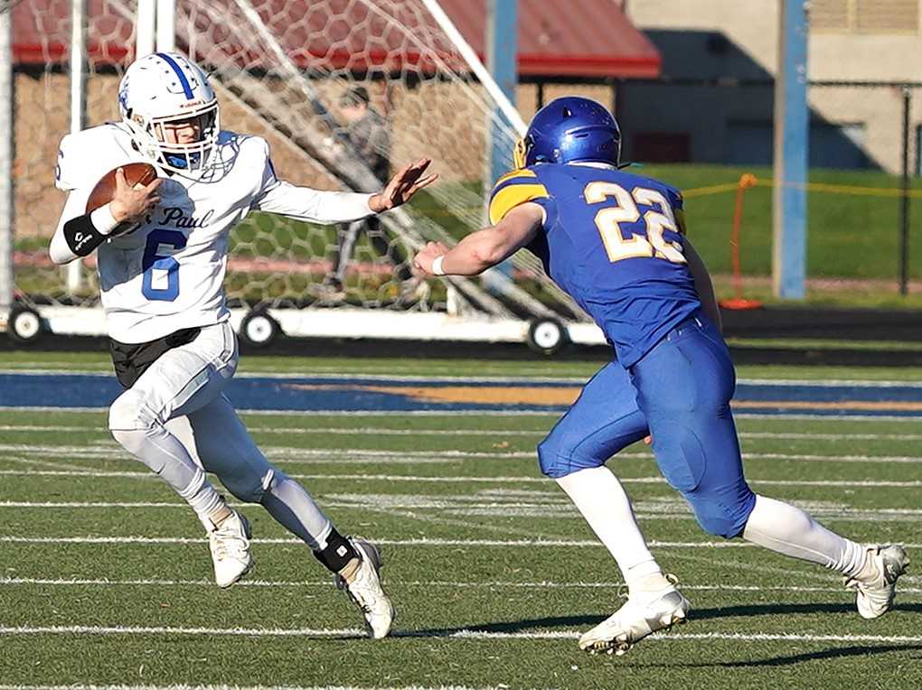 St. Paul quarterback Grady Wolf (6) is chased by Oakland's Shepard Brooksby in Saturday's 2A final. (Photo by J.R. Olson)