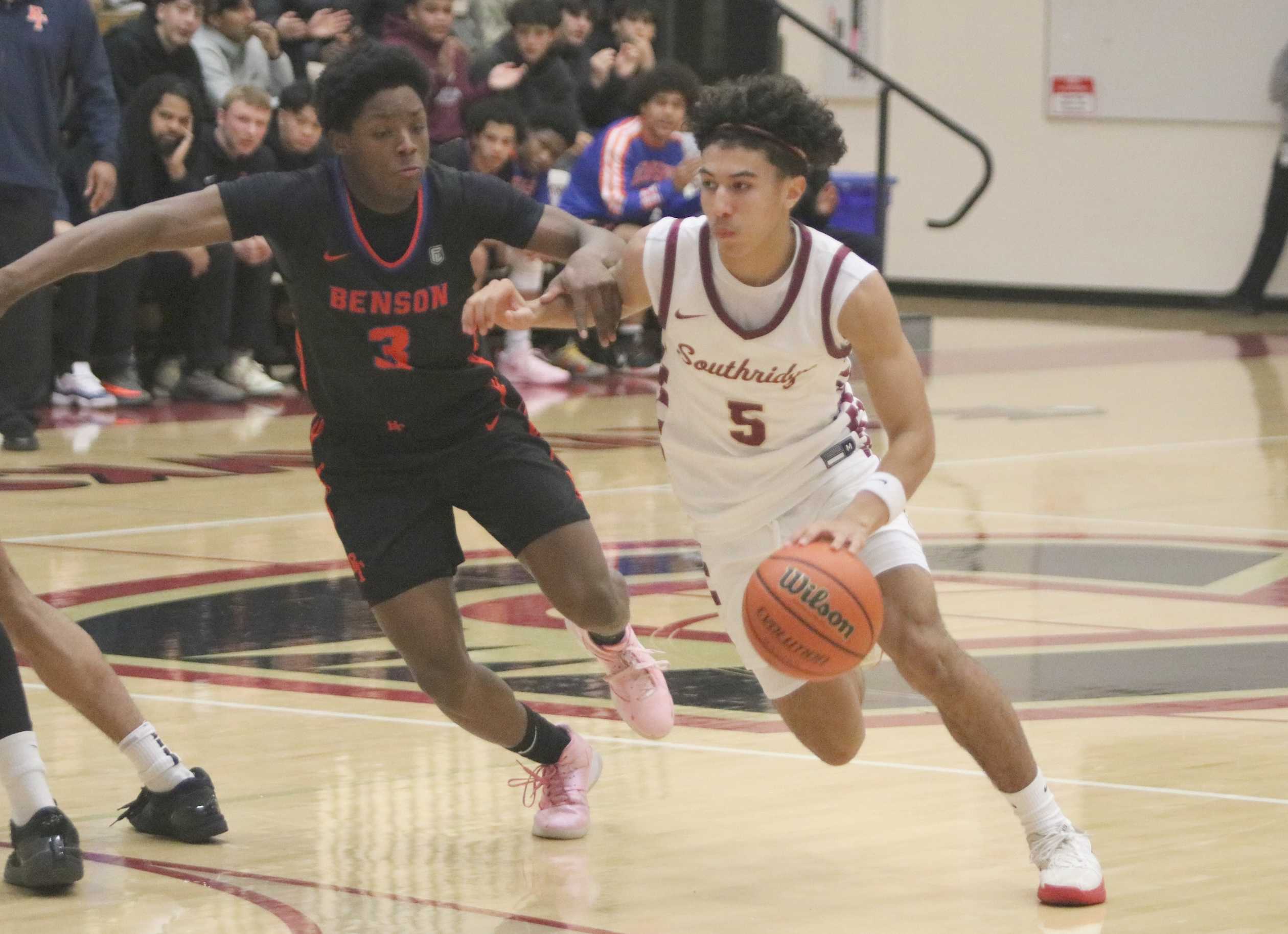 Southridge's Elijah Thompson (5) drives on Benson's Rachad Hudson during Friday's game at Southridge High. (Jim Beseda photo)