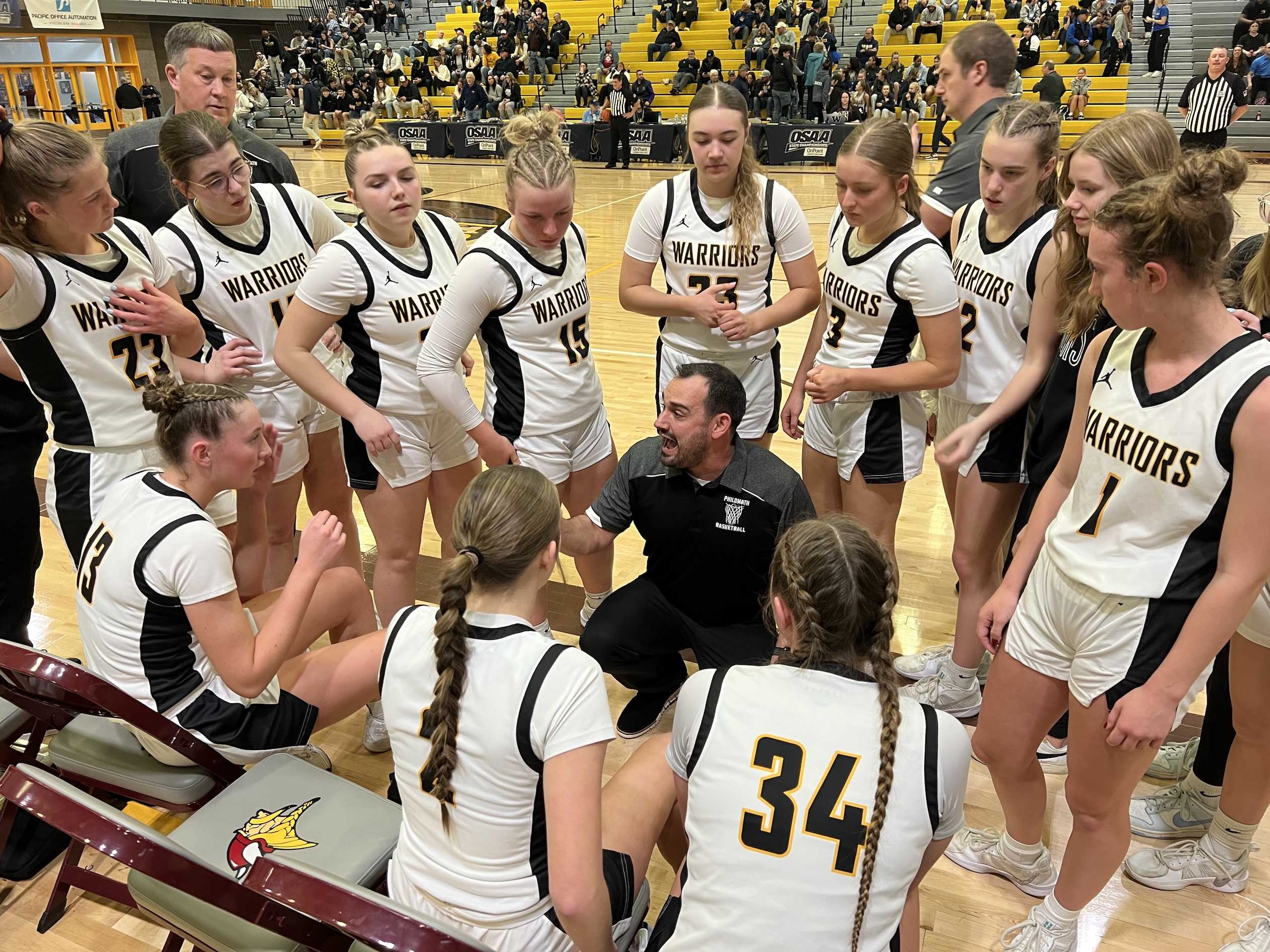 Philomath coach Ben Silva talks strategy with the Warriors leading 16-4 after the first period of Friday's 4A girls semifinal.