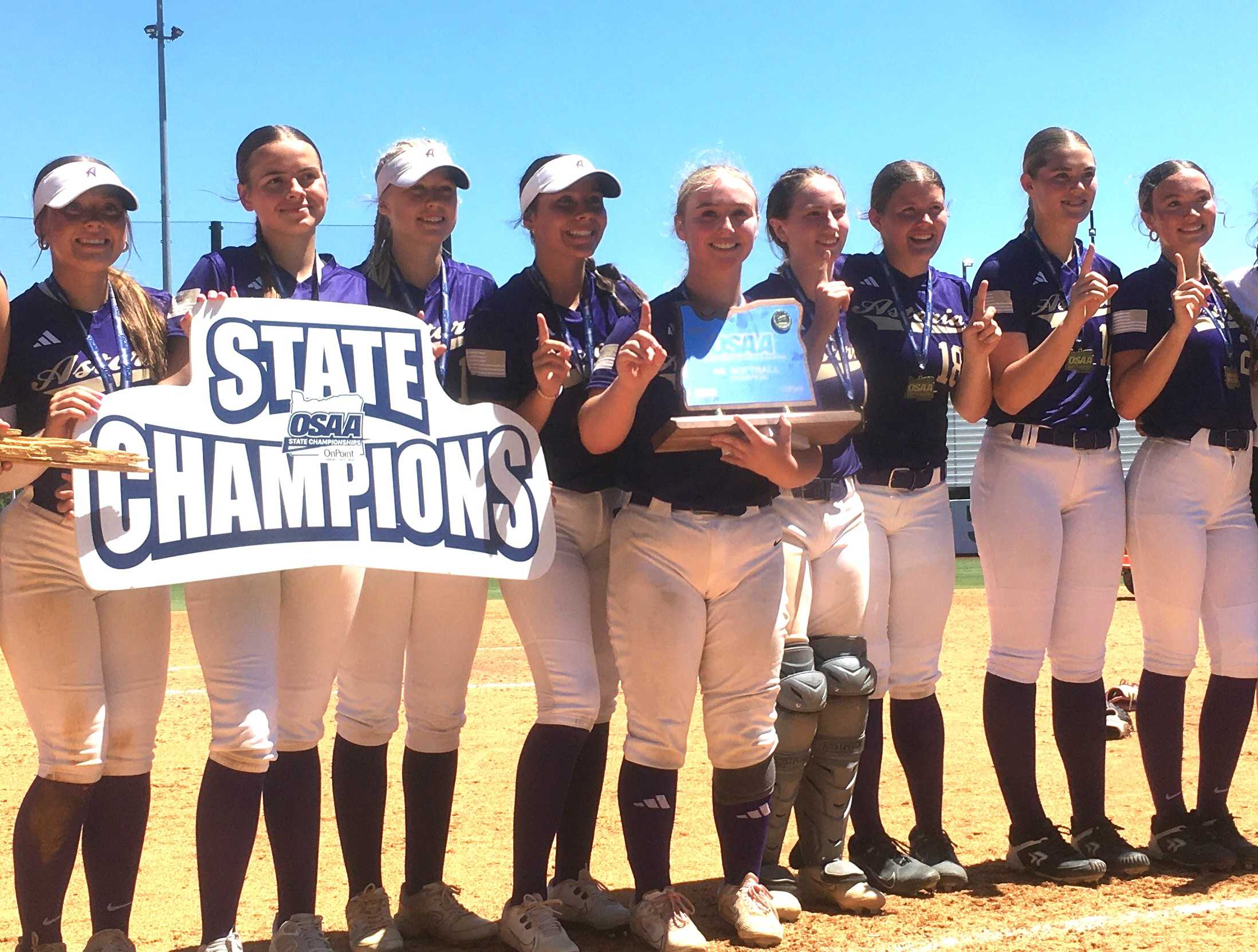 Maddie Wilkin (with trophy) and Astoria captured their first state championship Saturday by beating St. Helens in the 4A final.