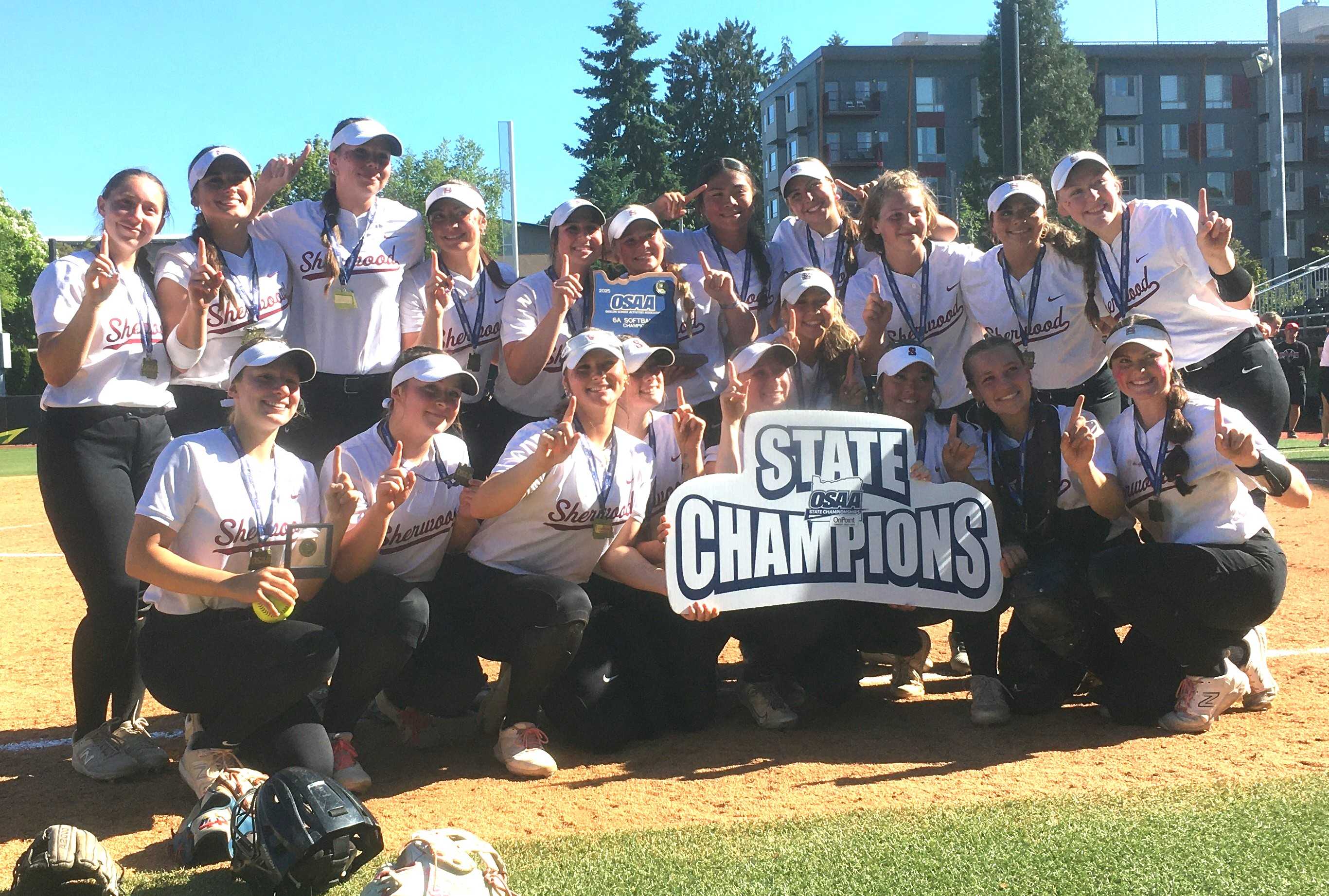 Sherwood's softball team poses with its first state championship trophy after beating North Medford in the 6A final Saturday.